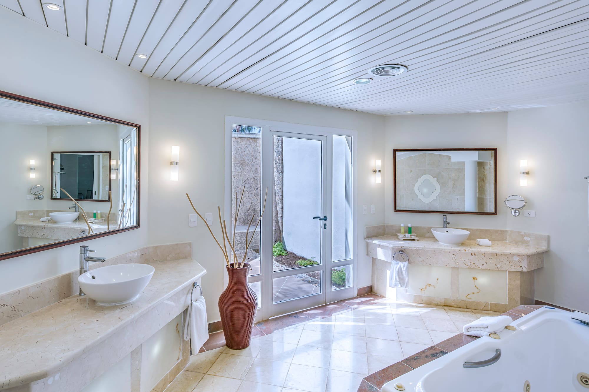 a bathroom with a tub and sinks