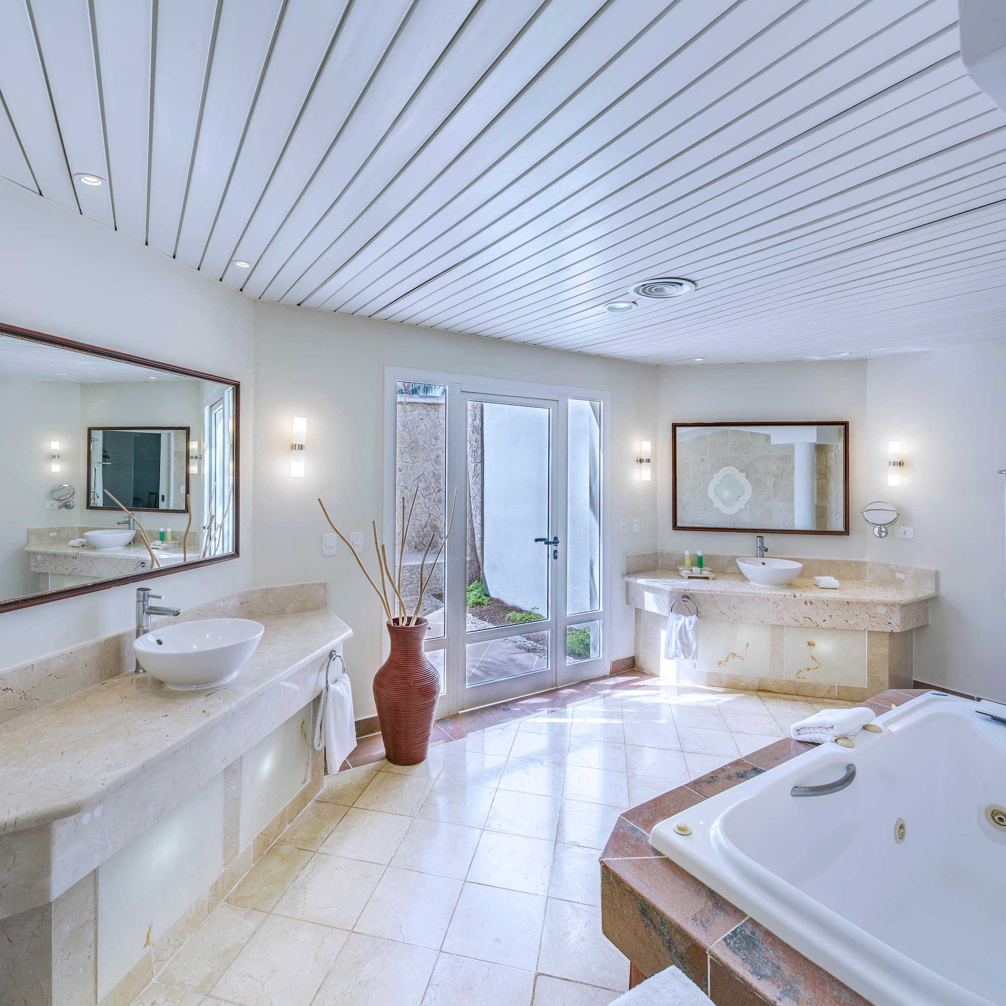 a bathroom with a tub and sinks