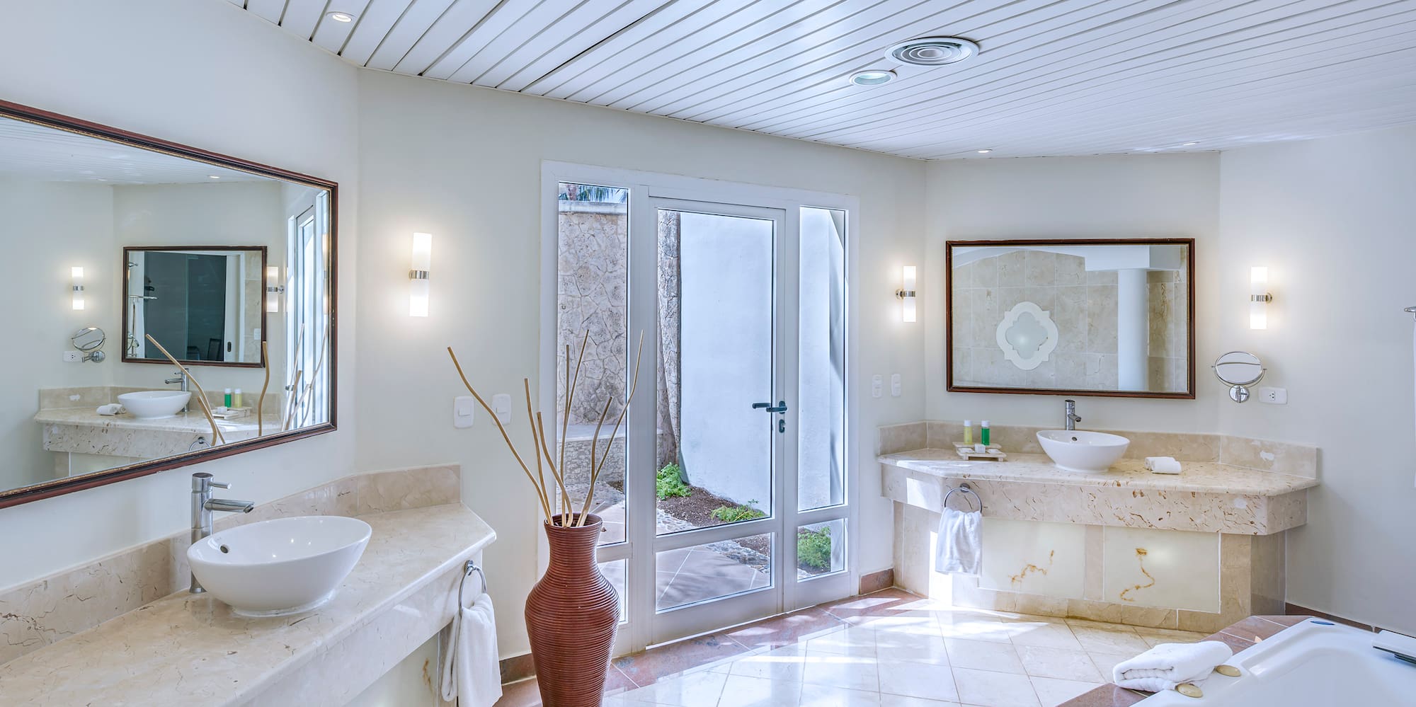 a bathroom with a tub and sinks