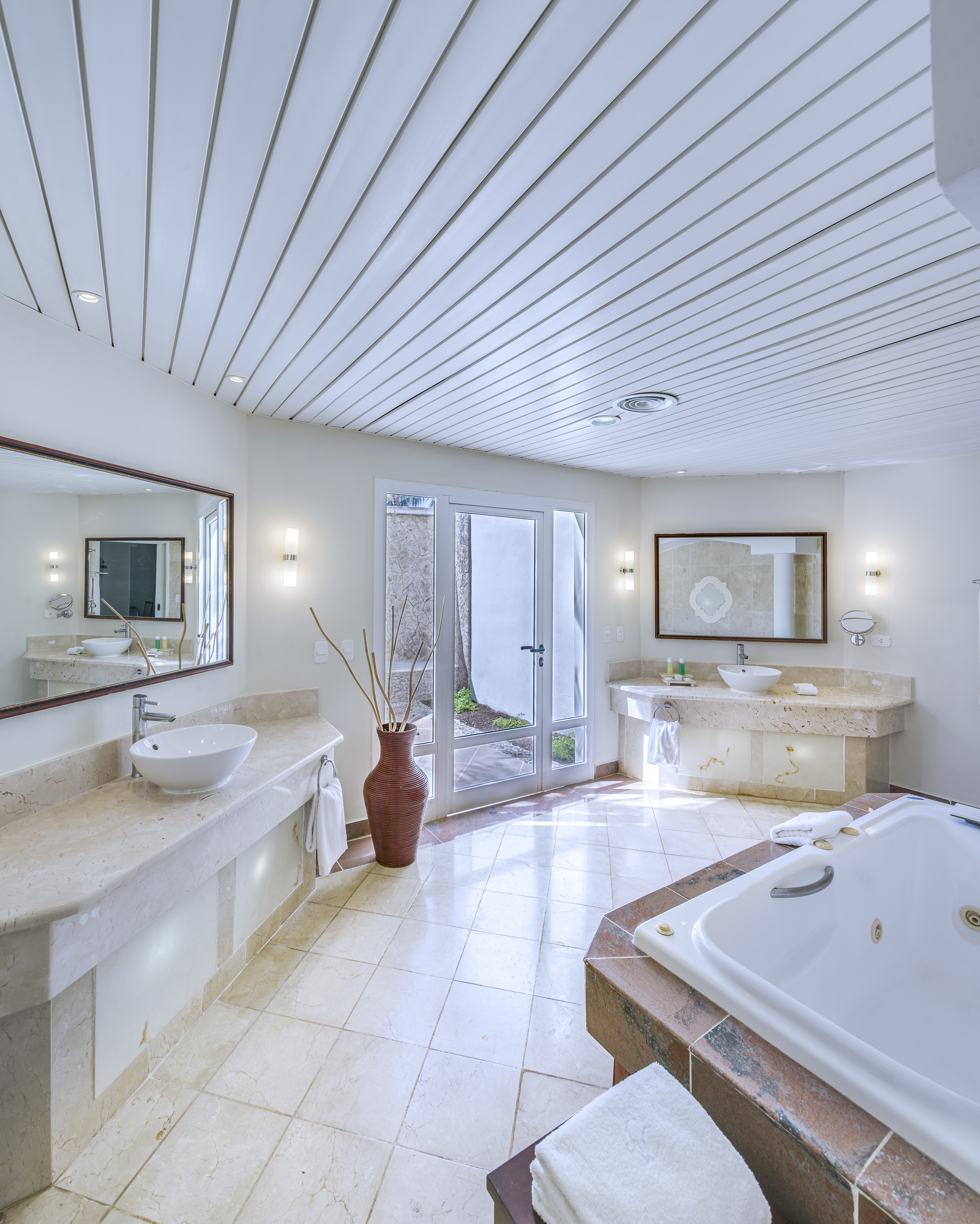 a bathroom with a tub and sinks