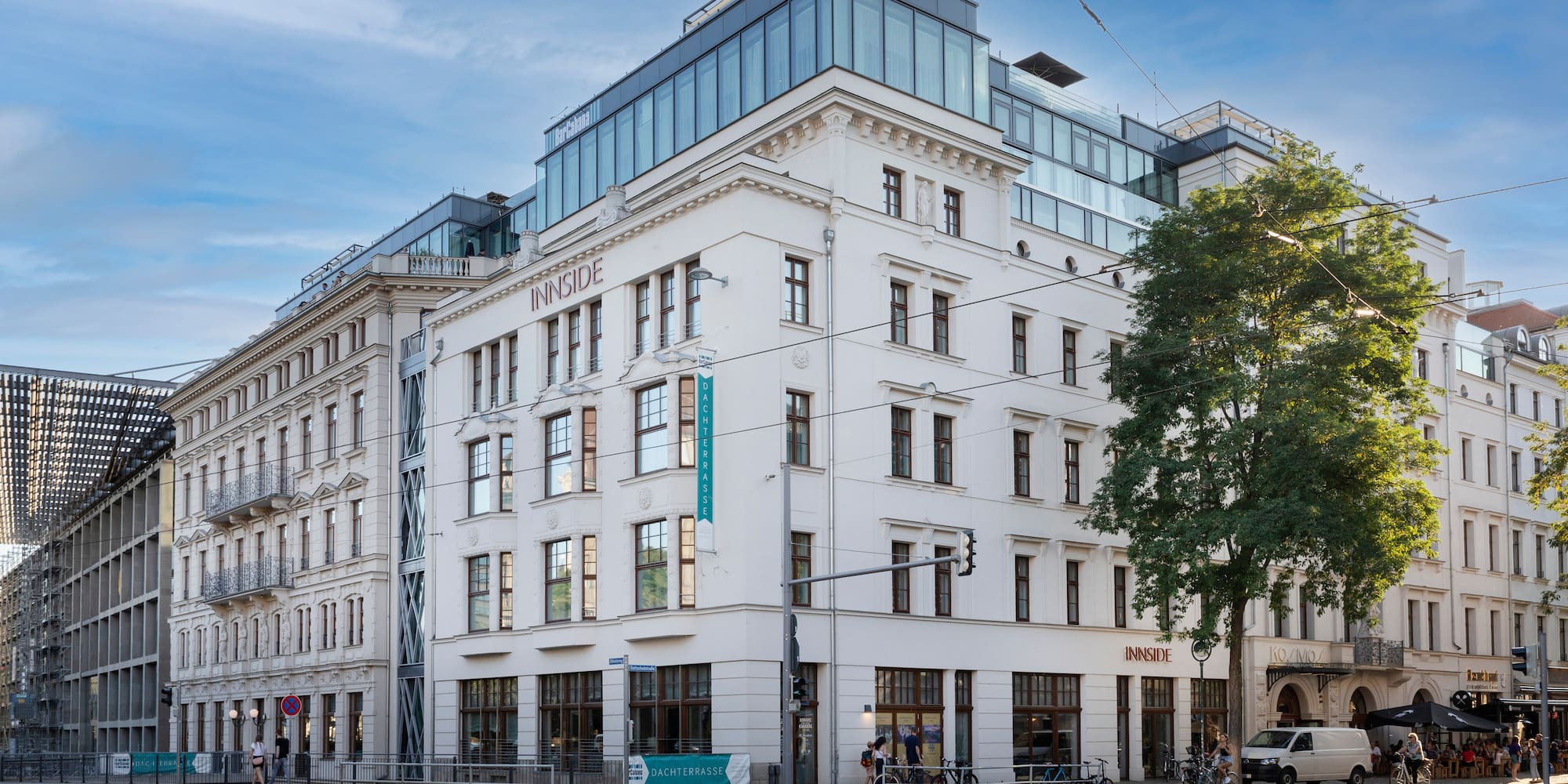 a white building with windows and a street corner