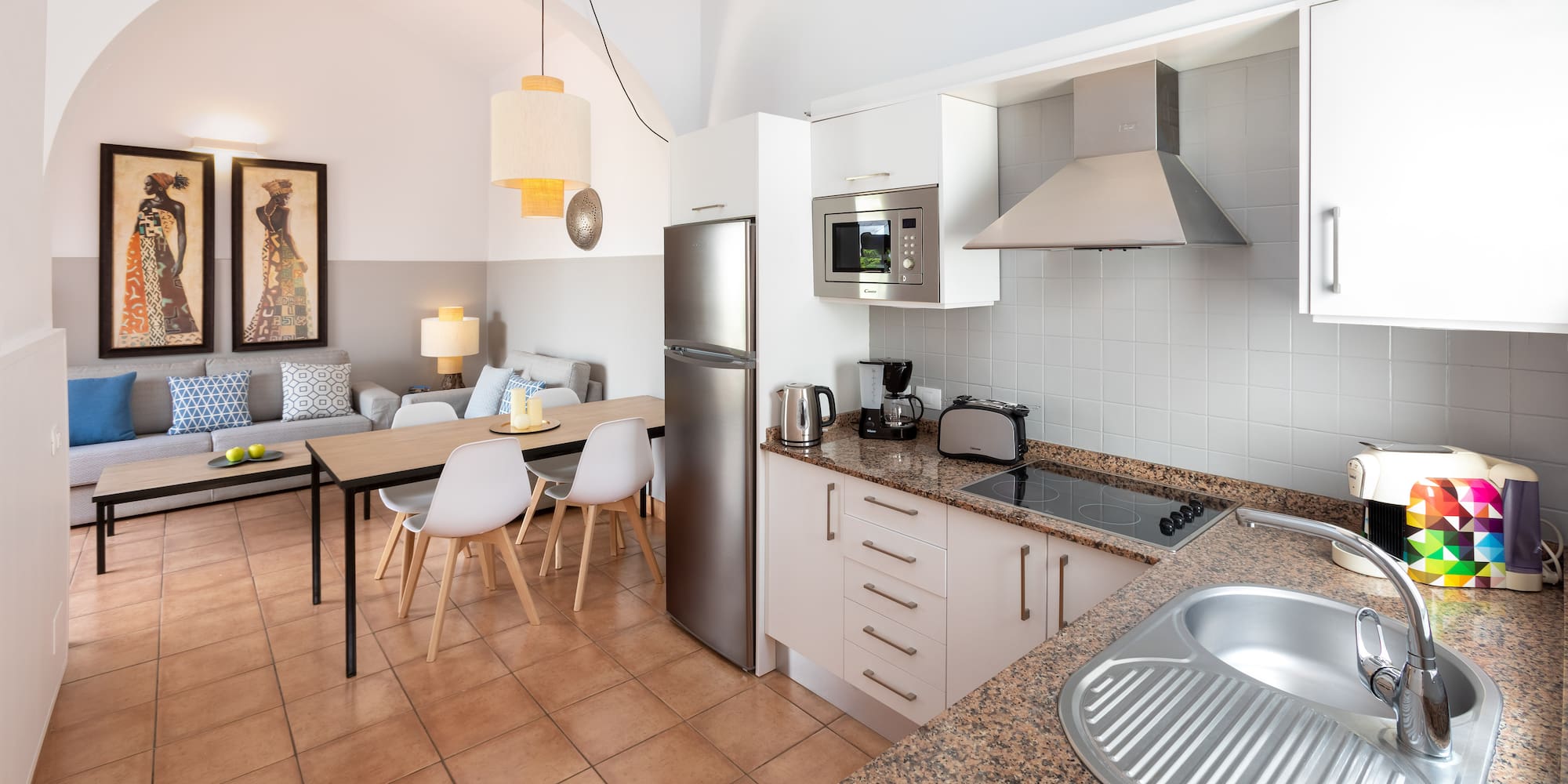 a kitchen with a table and chairs