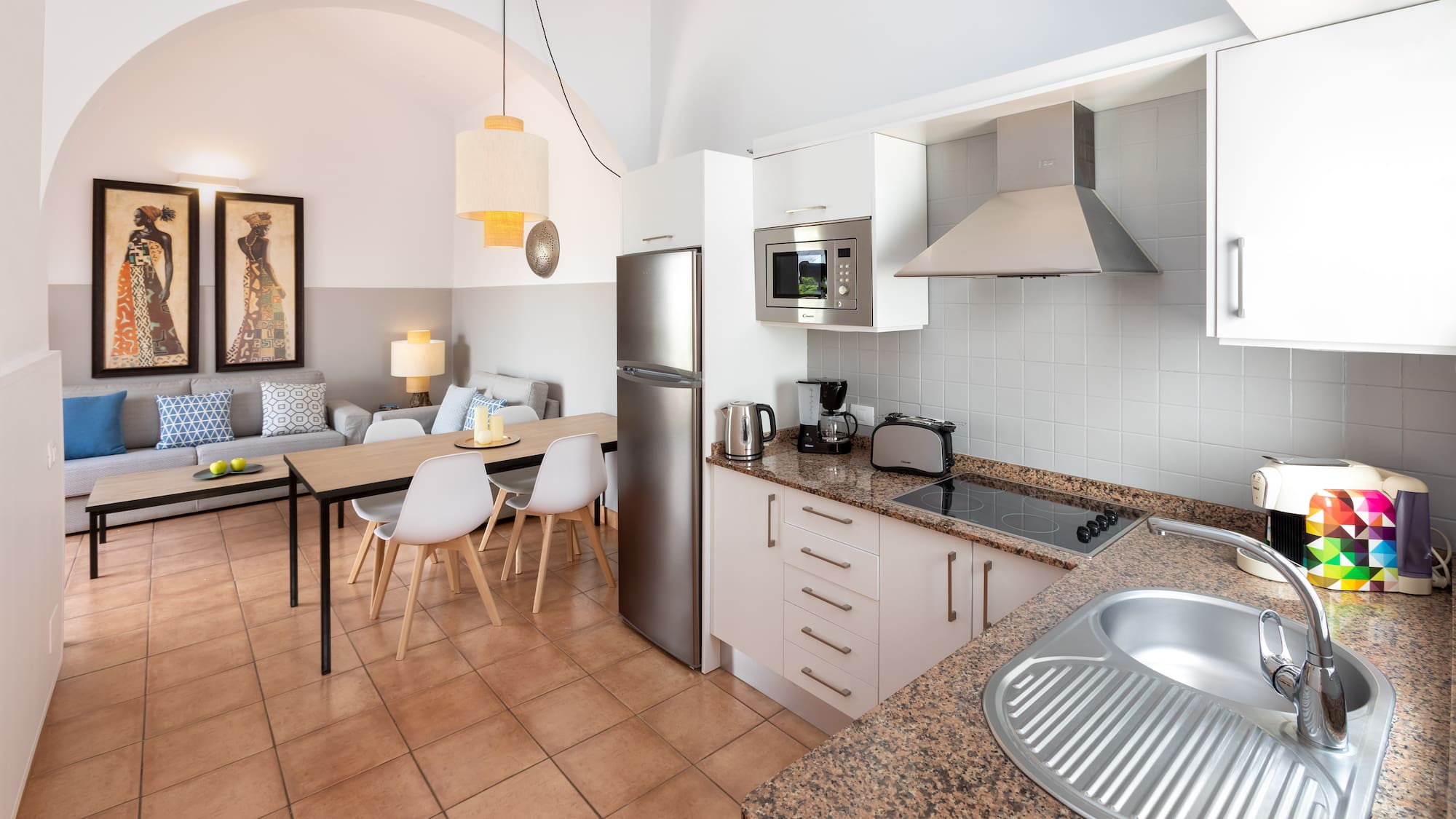 a kitchen with a table and chairs