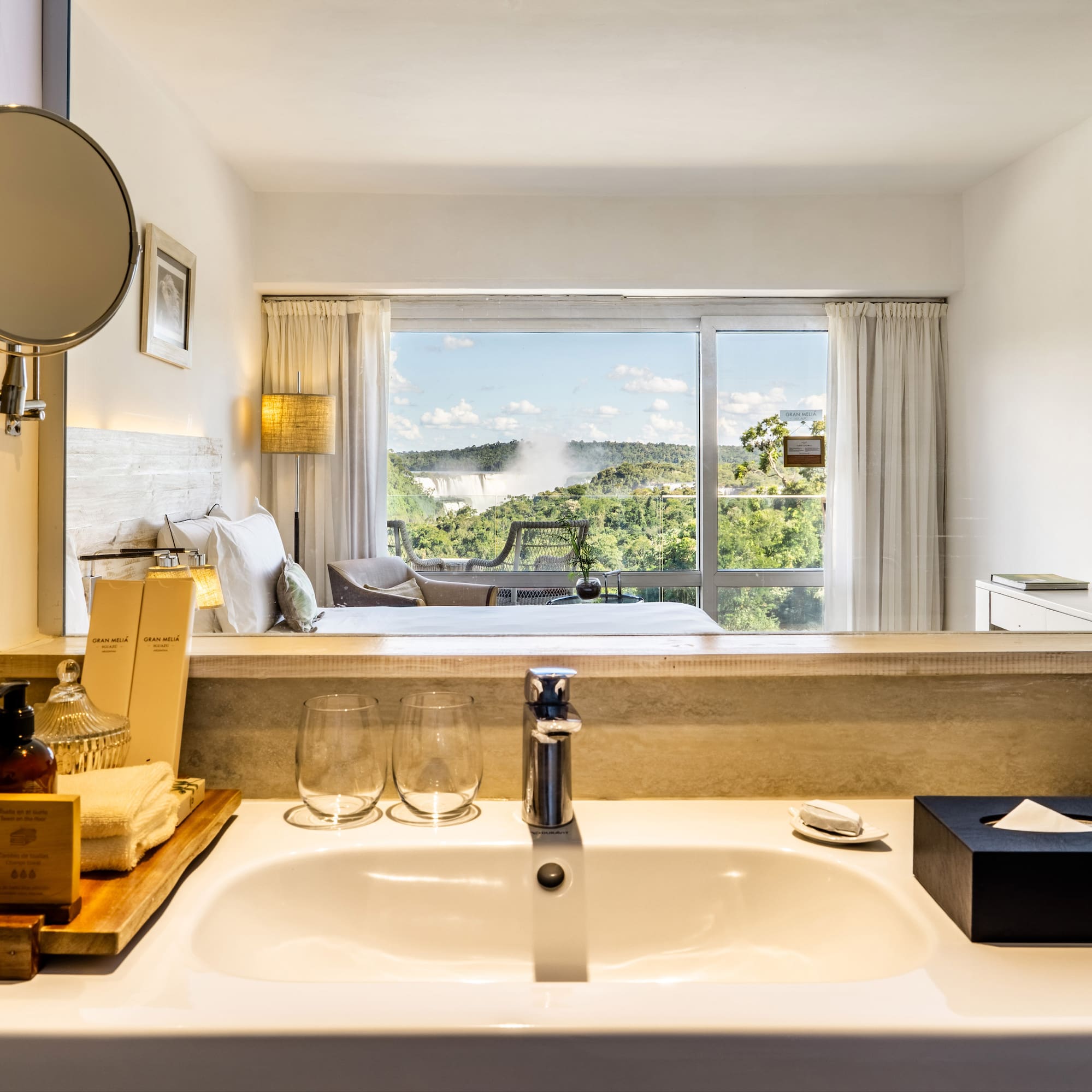a bathroom with a window and a view of the landscape