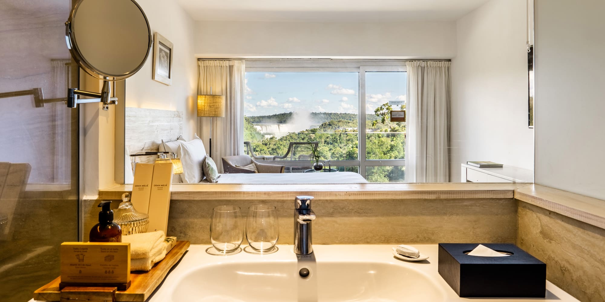 a bathroom with a window and a view of the landscape