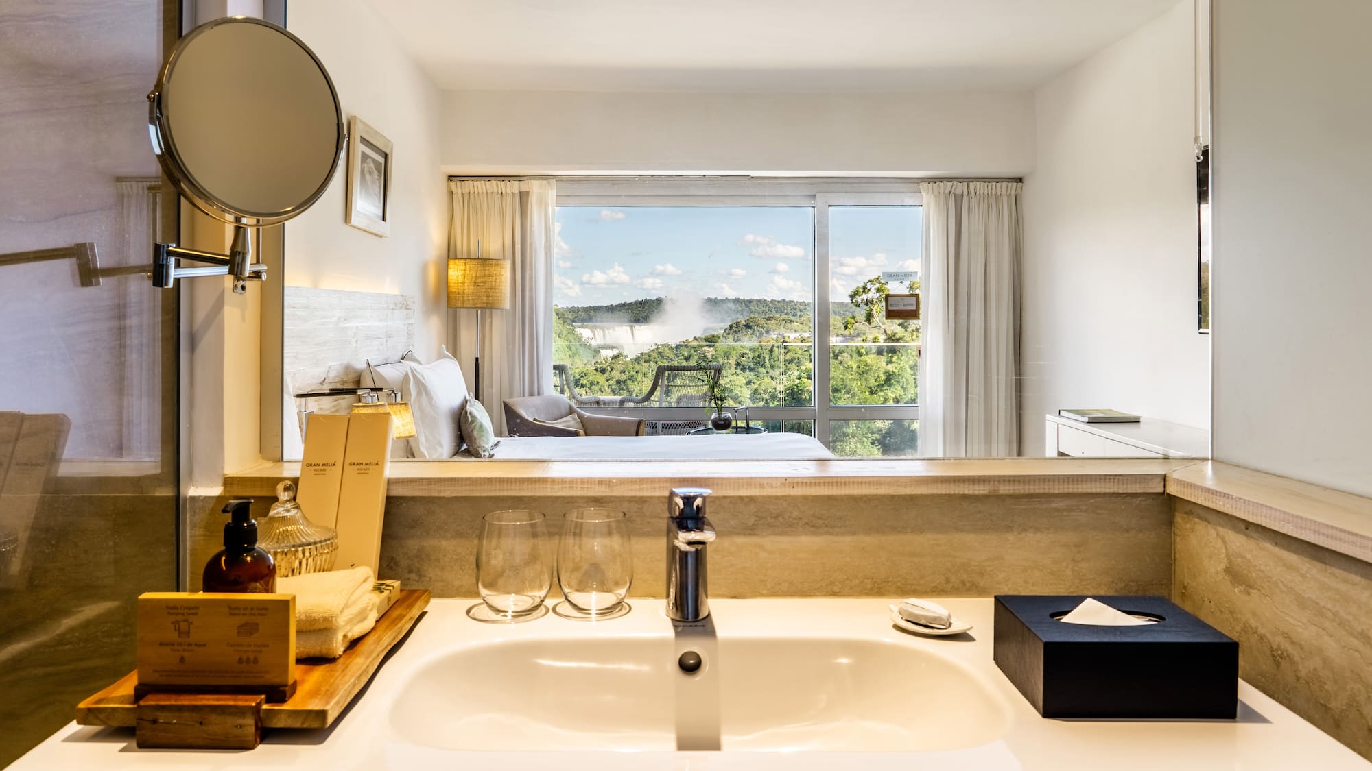 a bathroom with a window and a view of the landscape