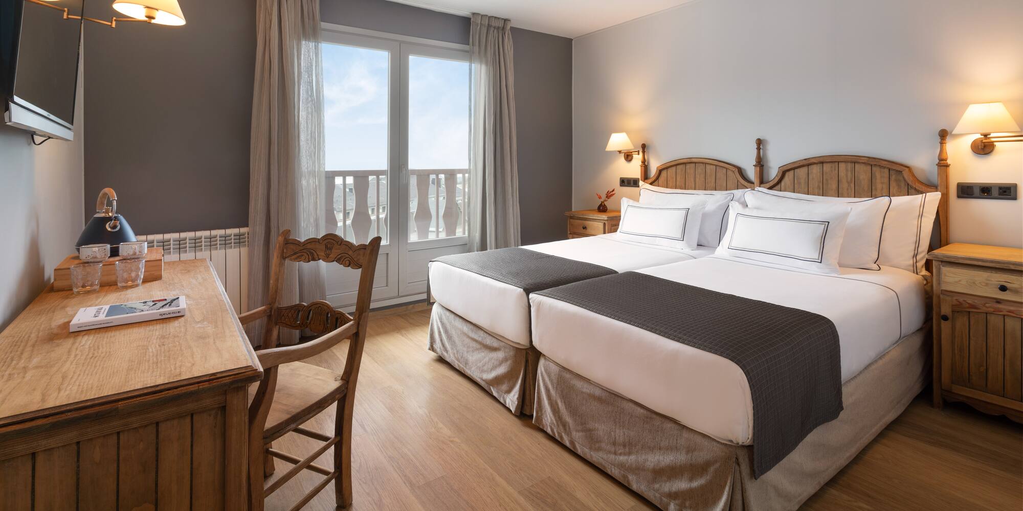 a room with two beds and a desk