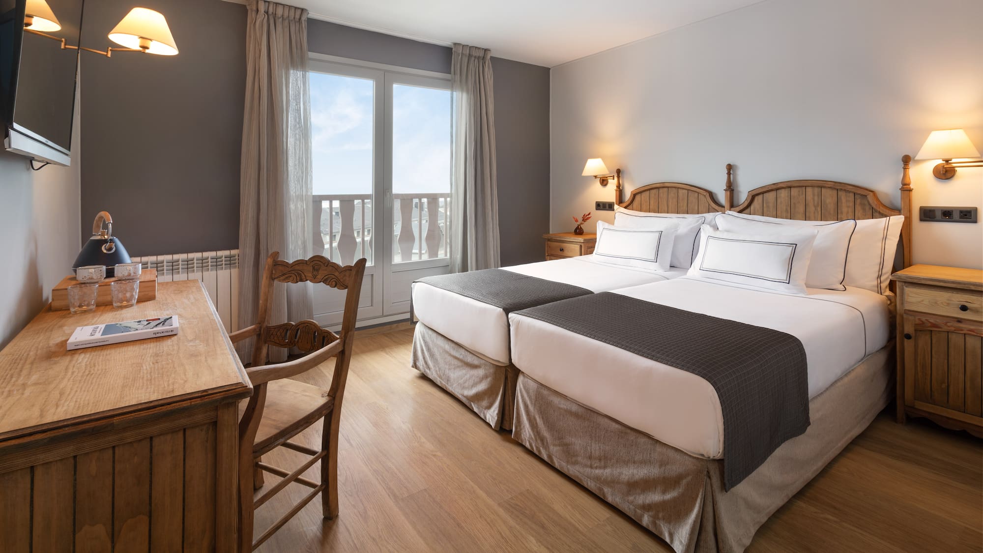 a room with two beds and a desk