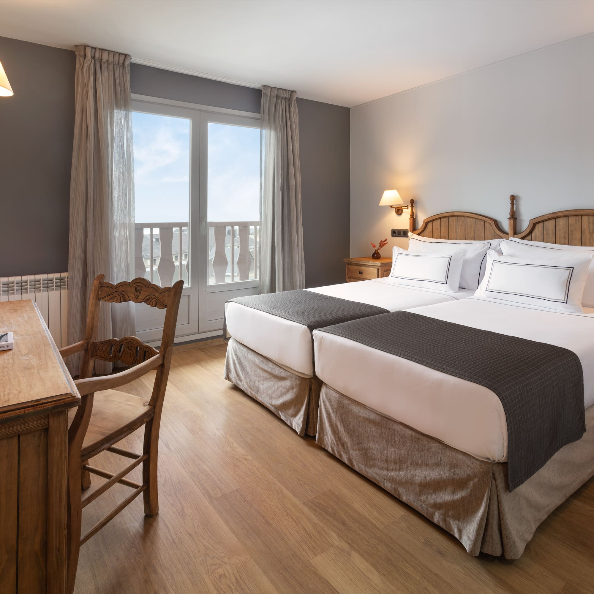 a room with two beds and a desk