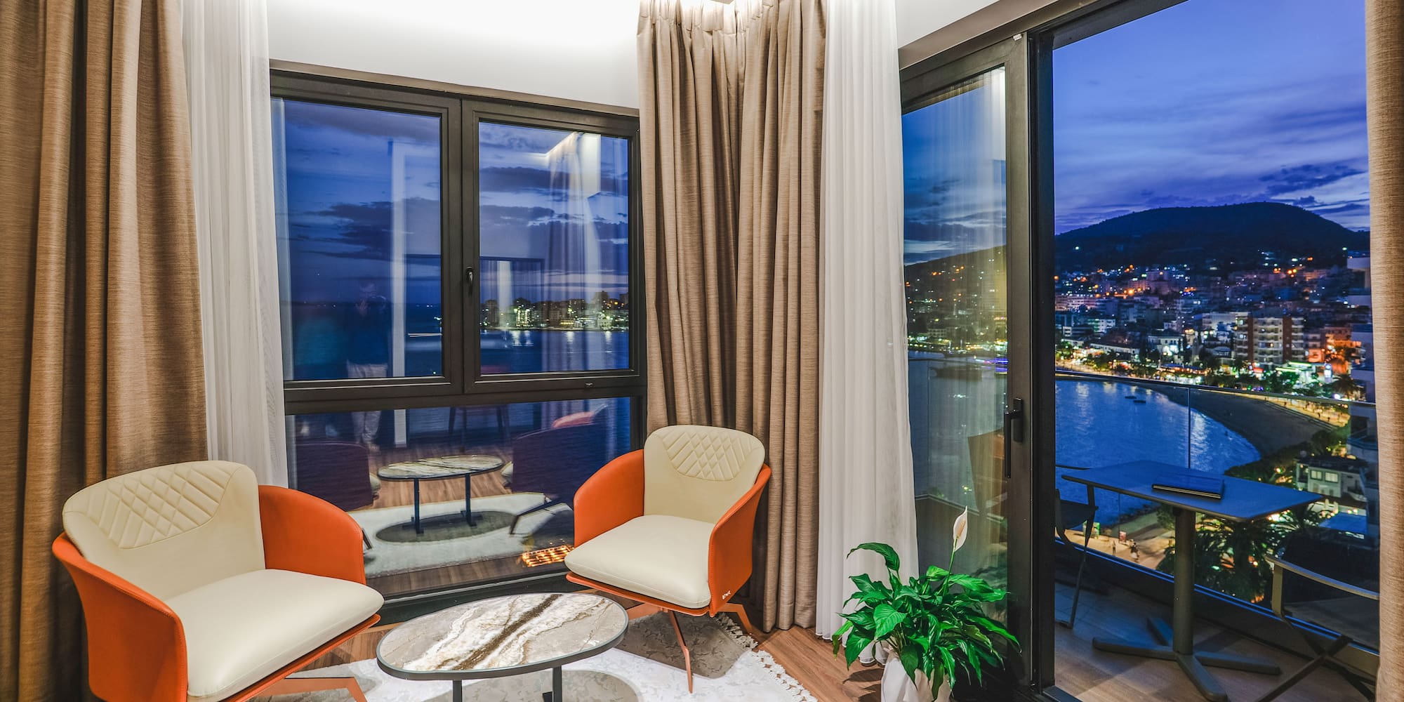 a room with a view of a city and a river