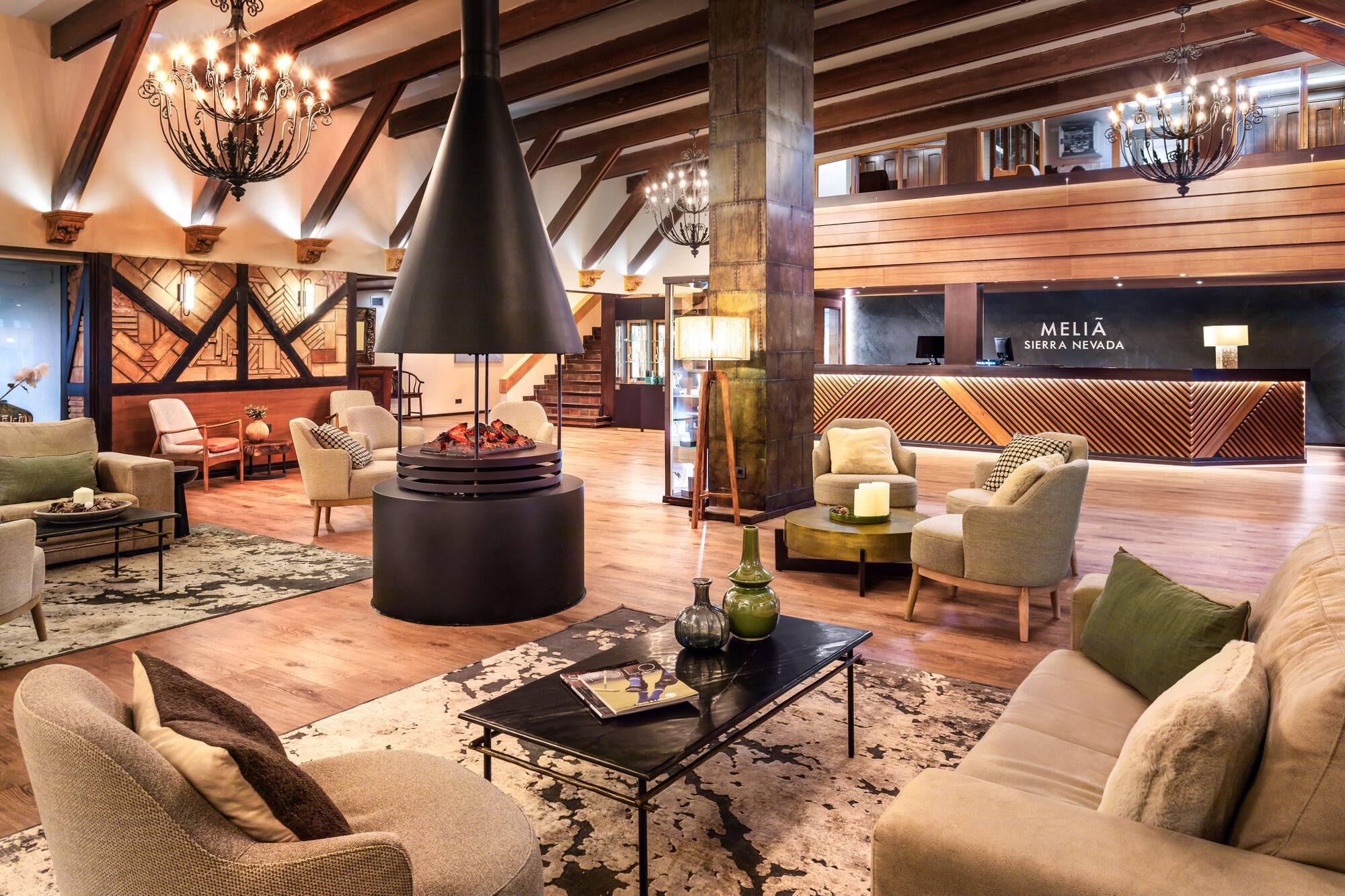 Meliã Sierra Nevada hotel lobby, lounge, and reception with modern fireplace.