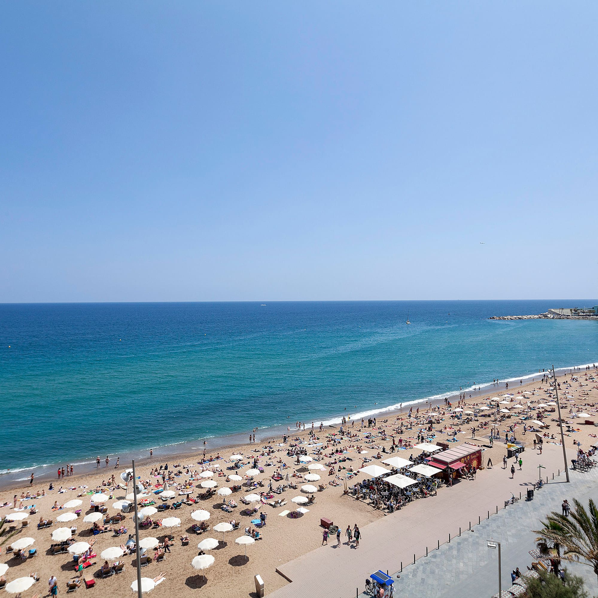 a beach with umbrellas and people on it