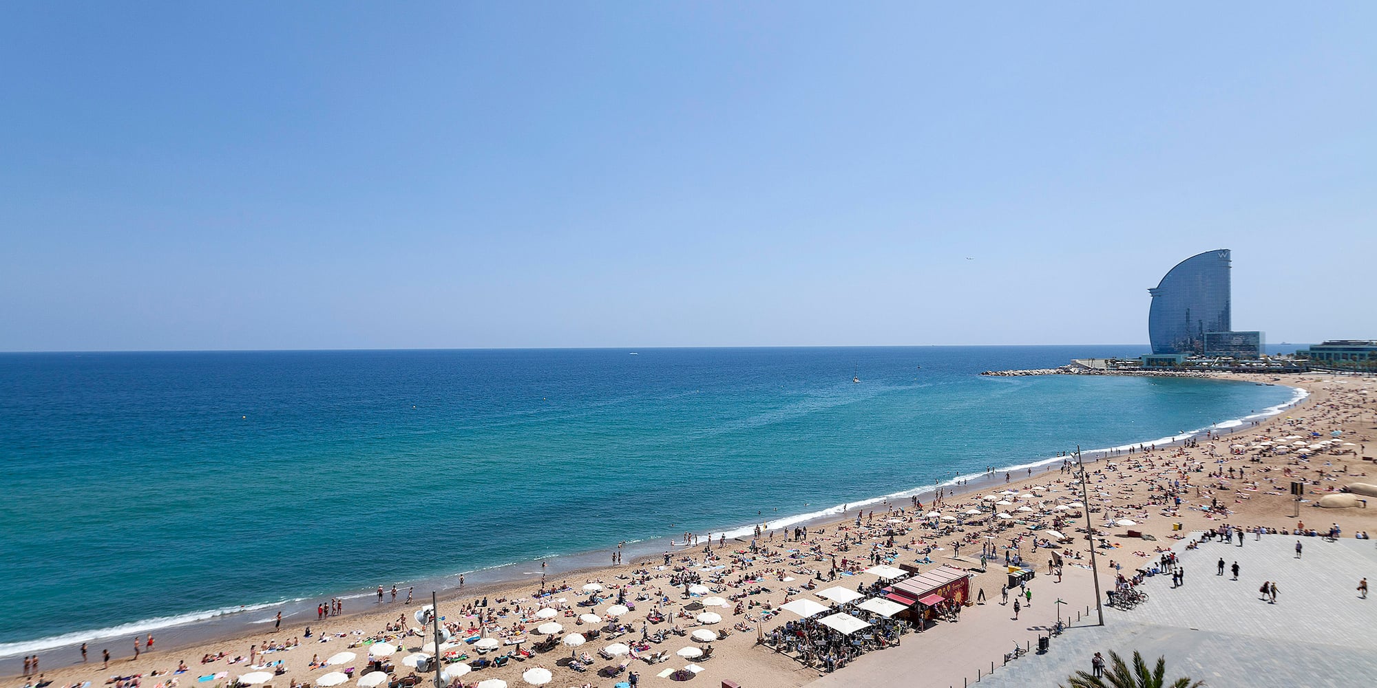 a beach with umbrellas and people on it