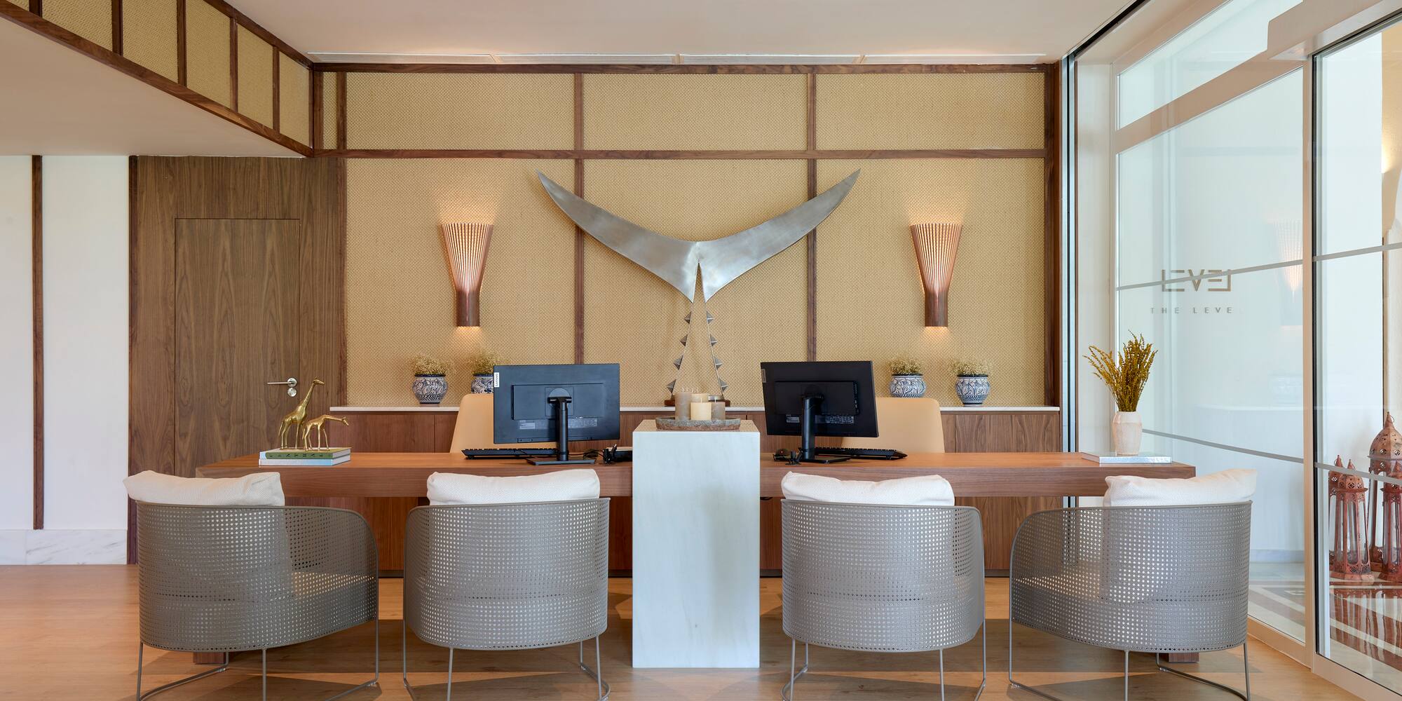 a room with a desk and chairs