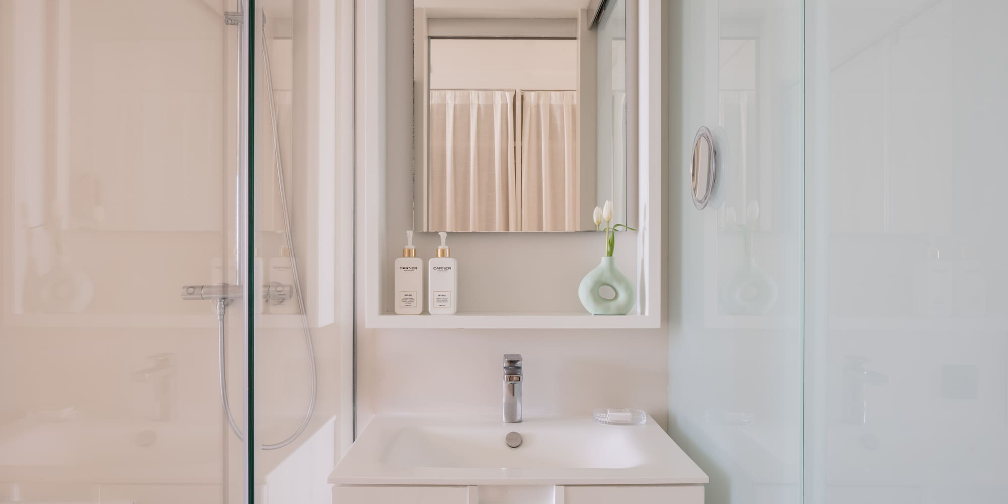 a bathroom with a mirror and a sink