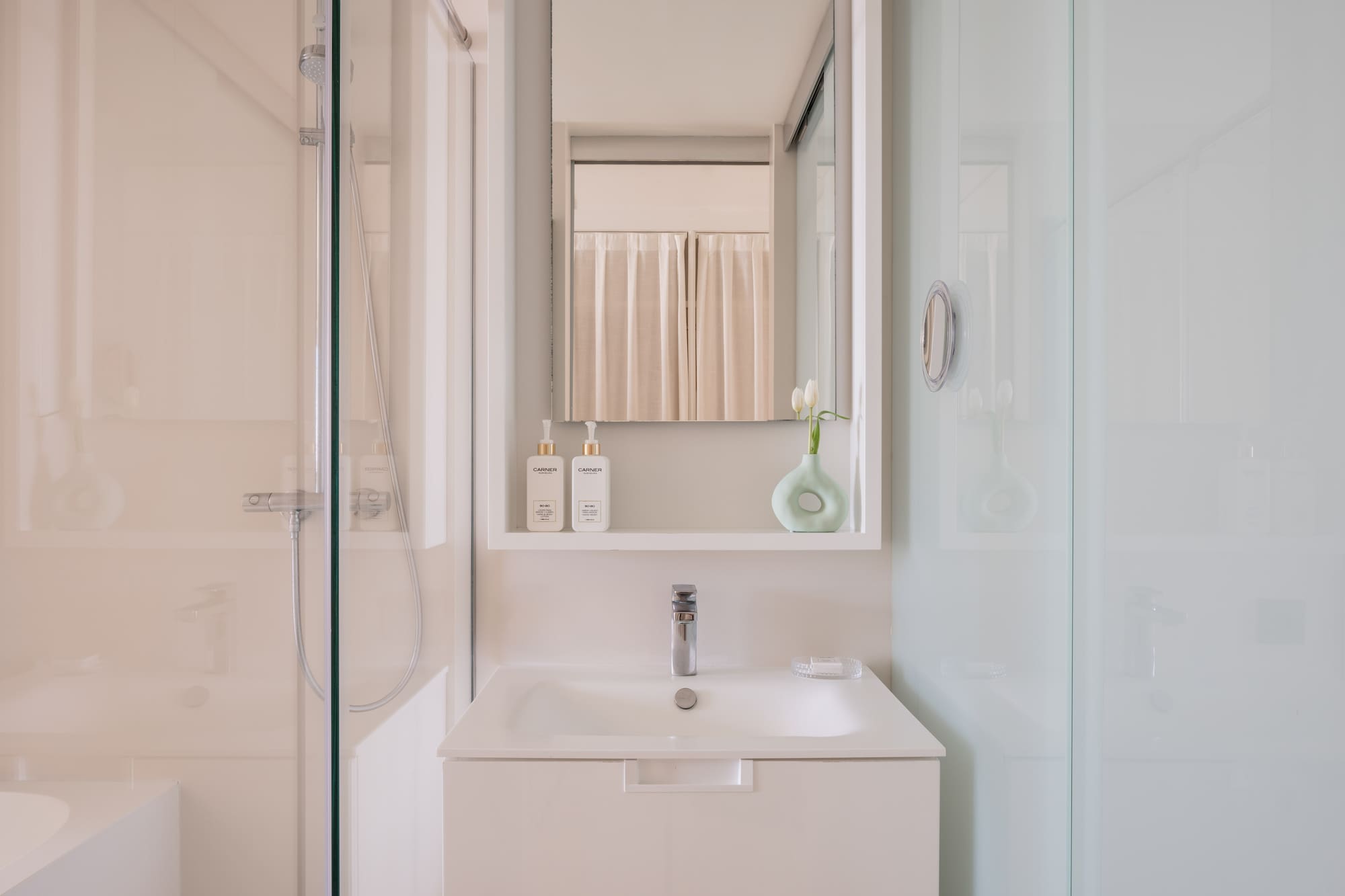 a bathroom with a mirror and a sink