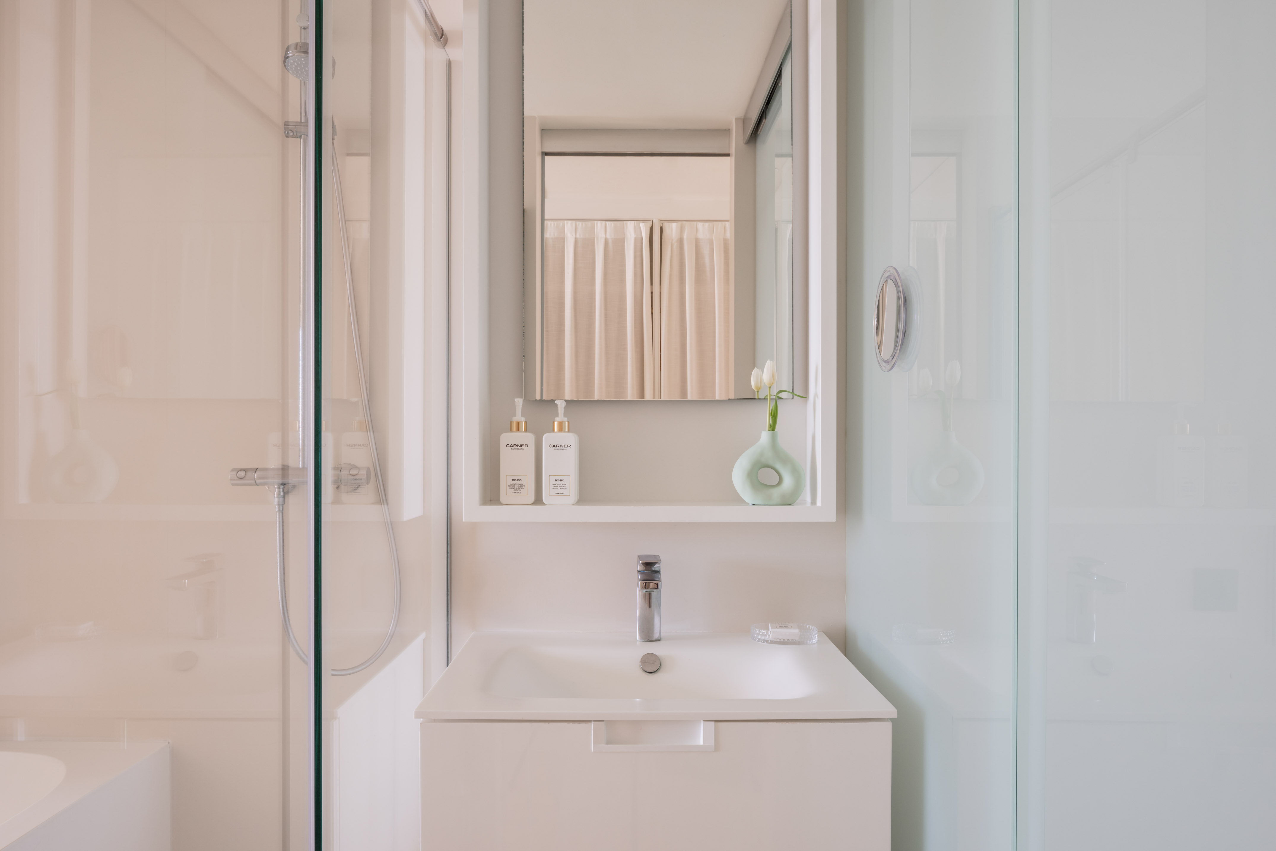 a bathroom with a mirror and a sink
