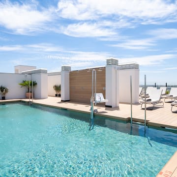 a swimming pool with lounge chairs and a deck