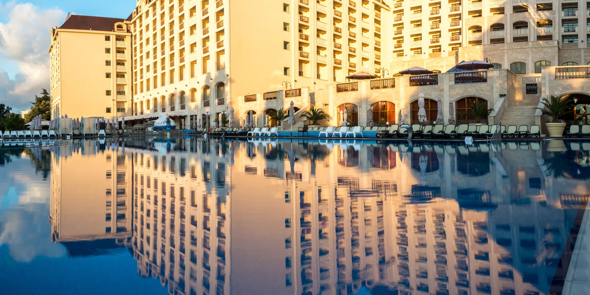 a large building with a pool in the background