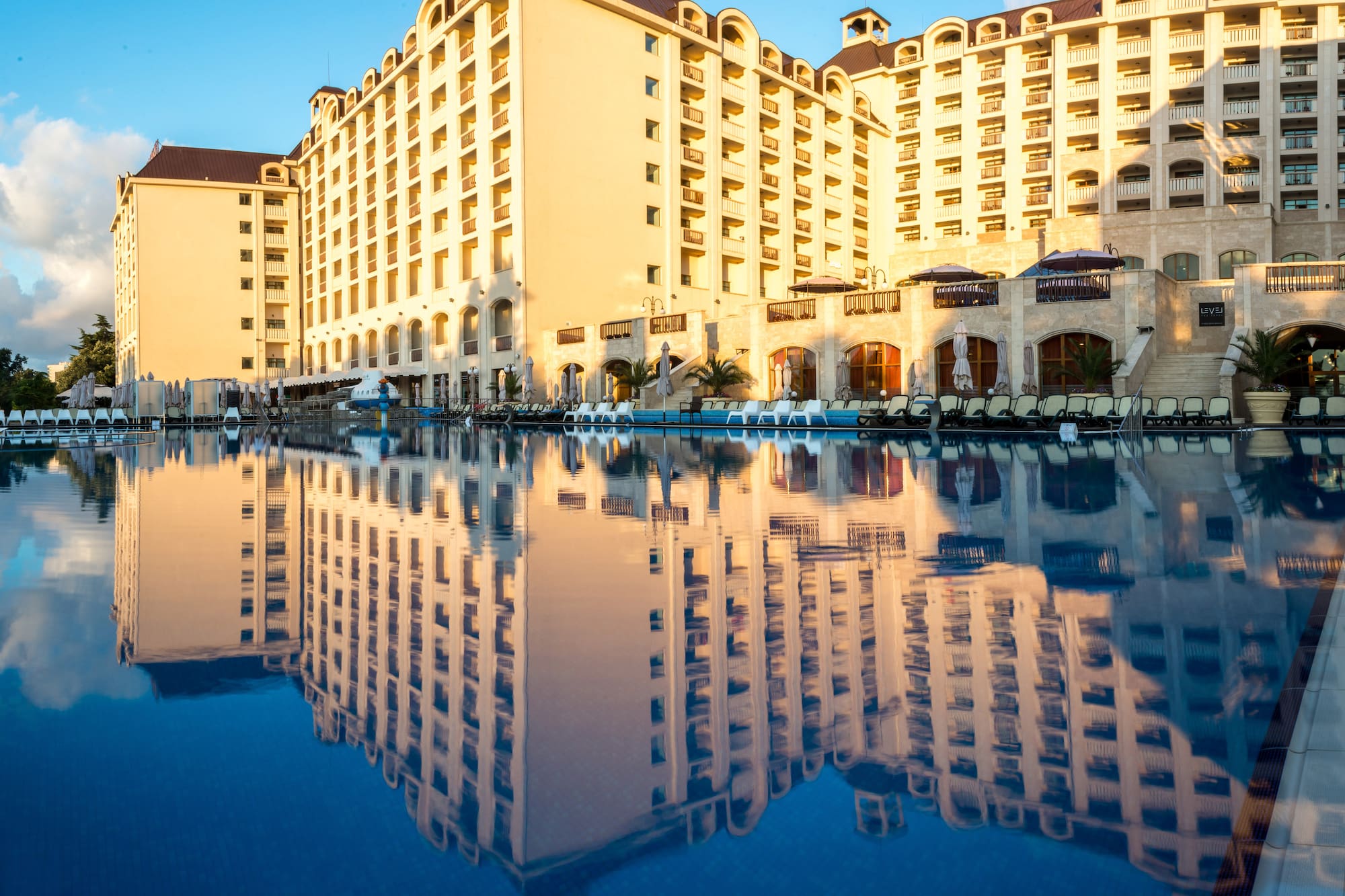 a large building with a pool in the background