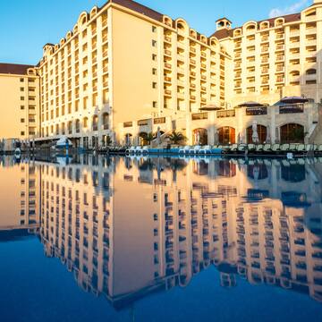 a large building with a pool in the background