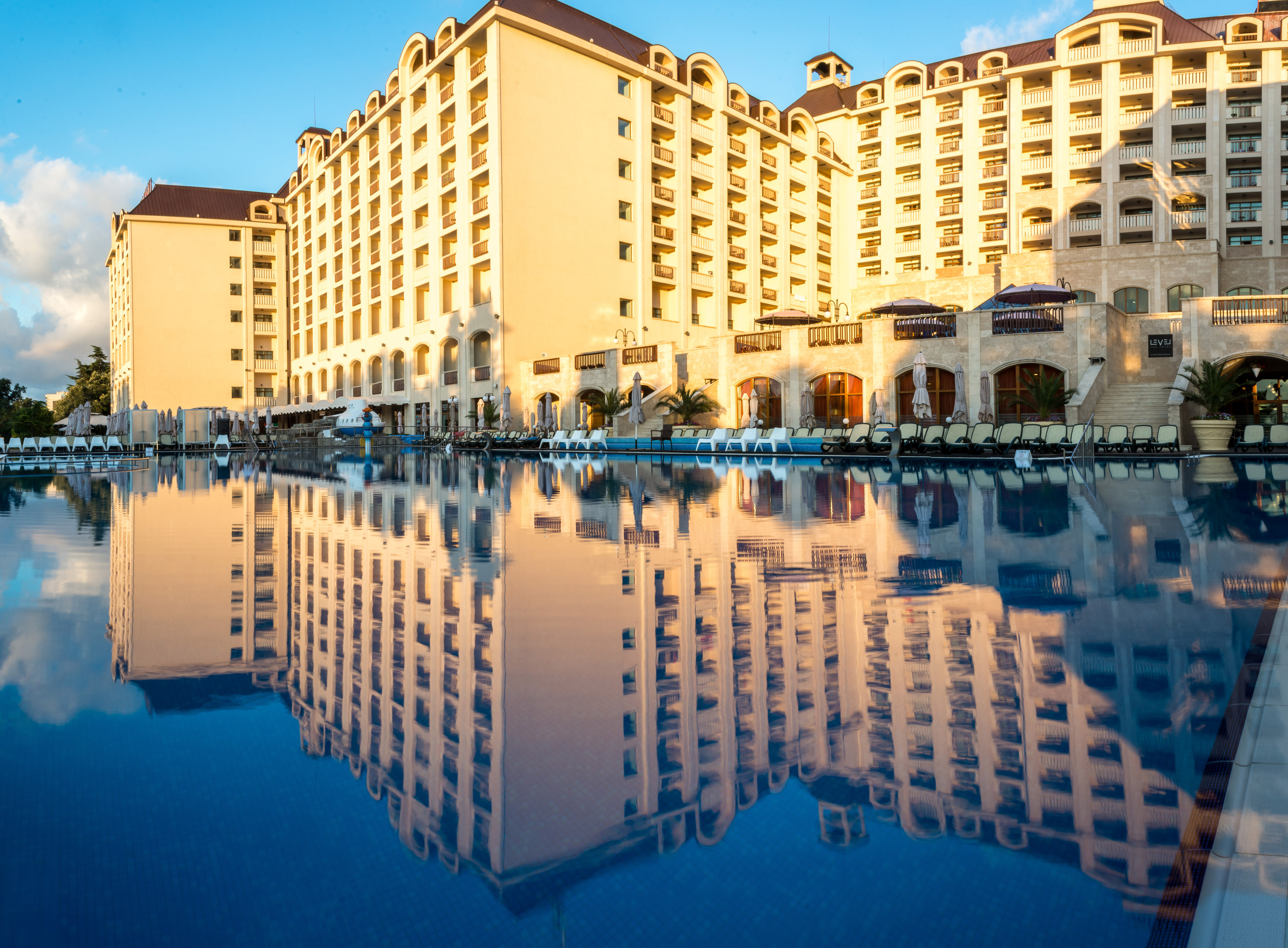 a large building with a pool in the background