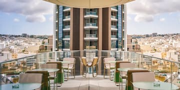 a balcony with tables and chairs