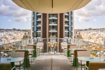 a balcony with tables and chairs