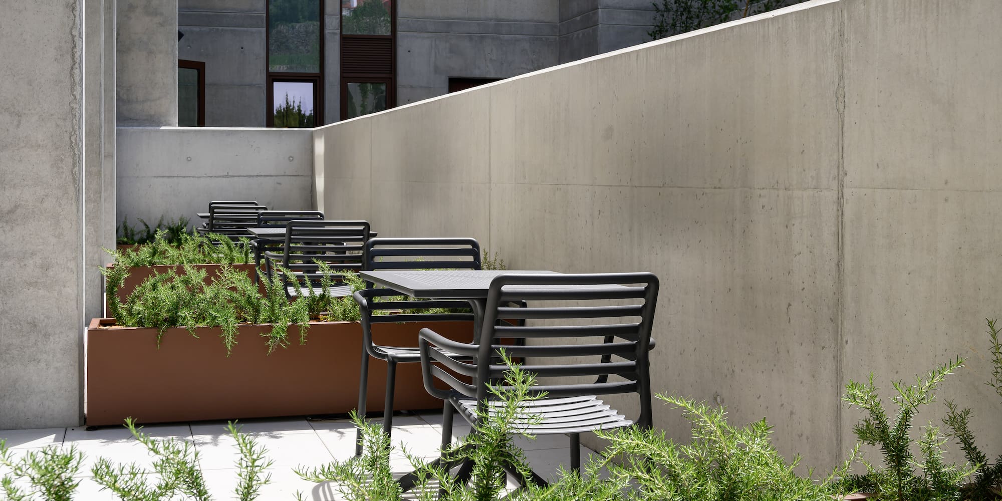 a patio with chairs and plants