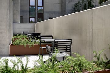a patio with chairs and plants