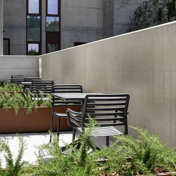 a patio with chairs and plants