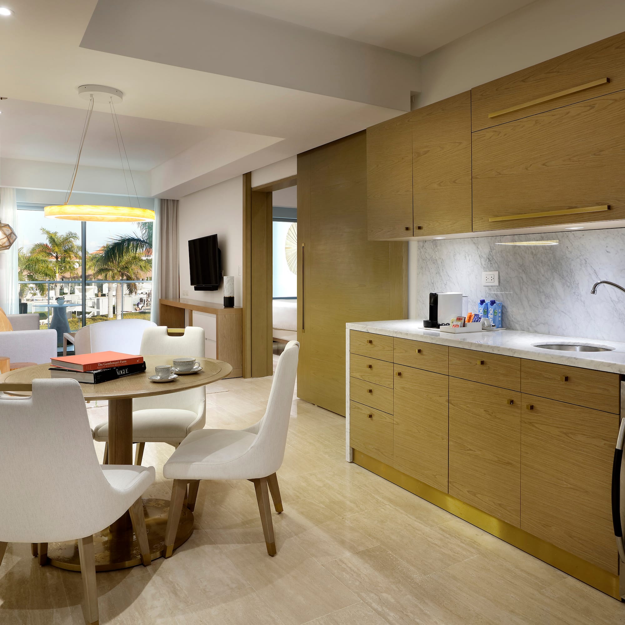 a kitchen and dining area with a table and chairs