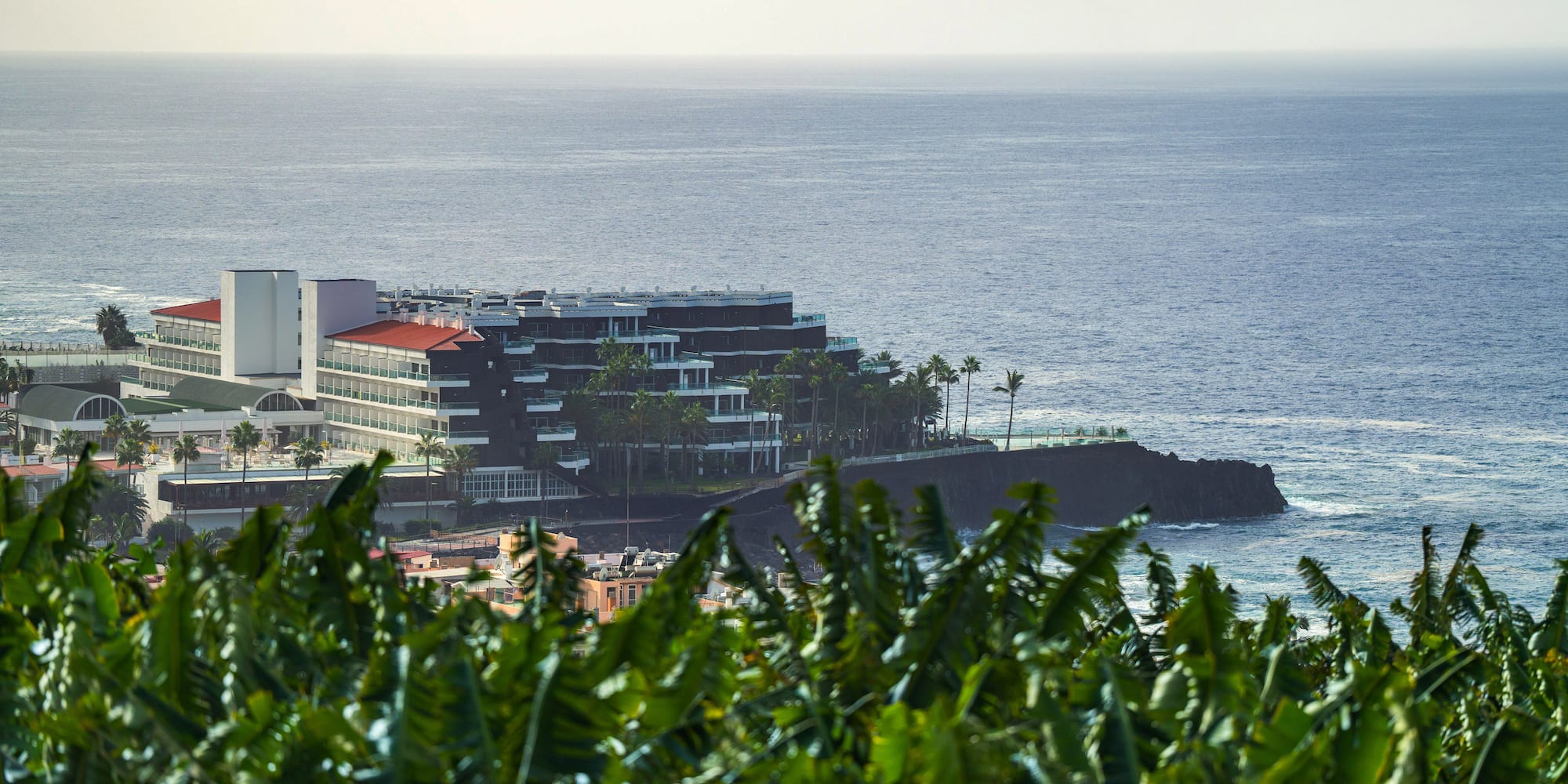 a building on a rocky island by the ocean