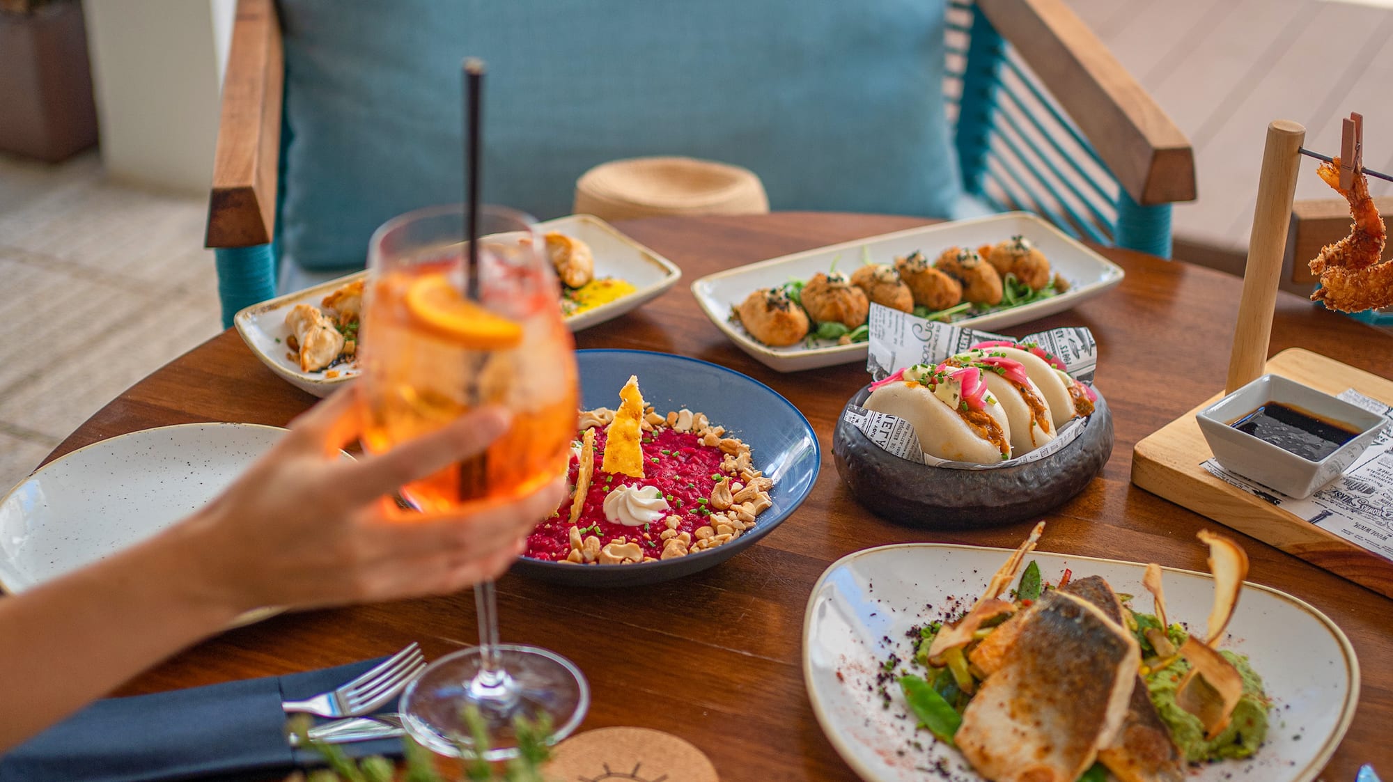 a table with plates of food and a drink