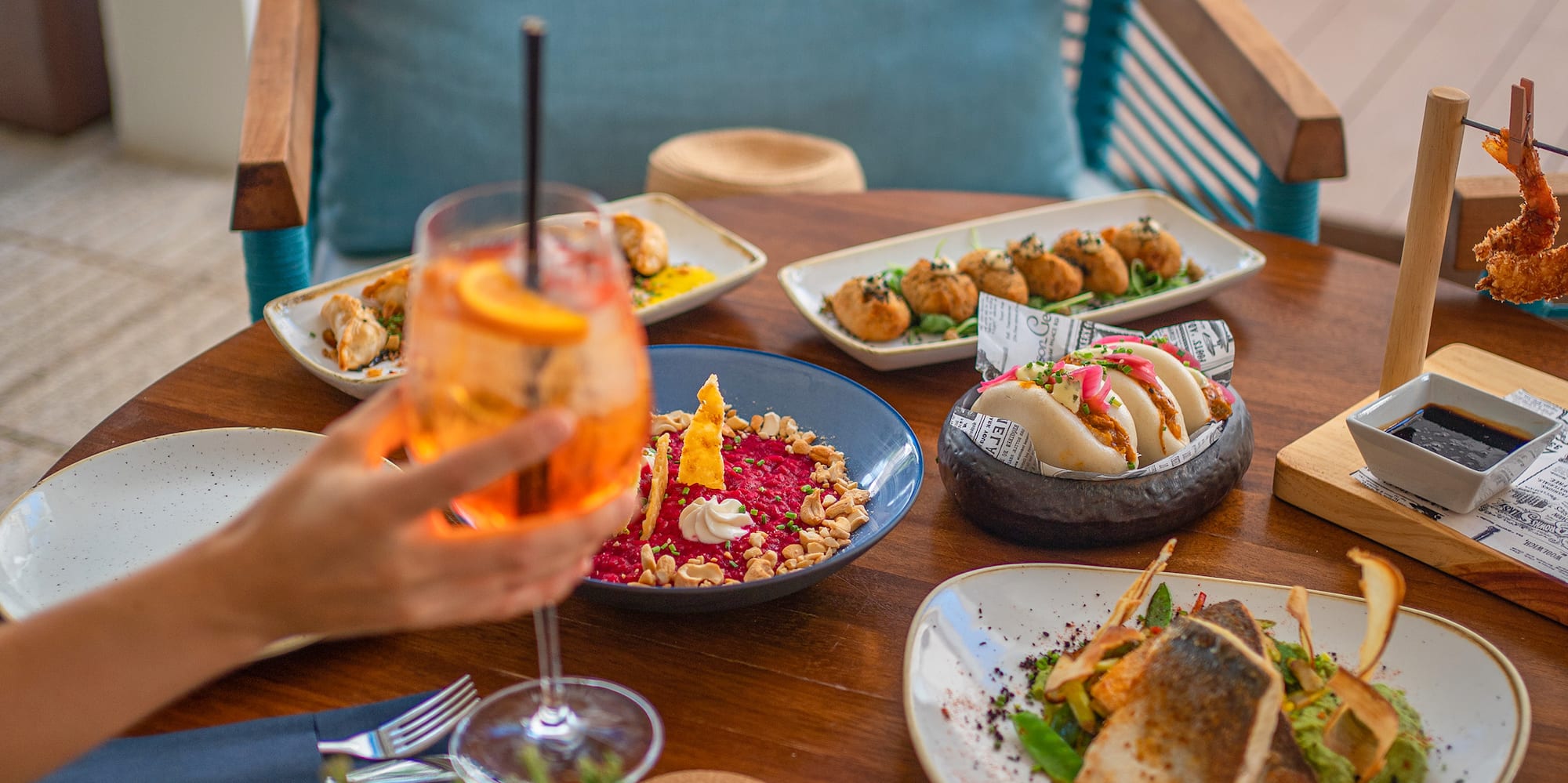 a table with plates of food and a drink