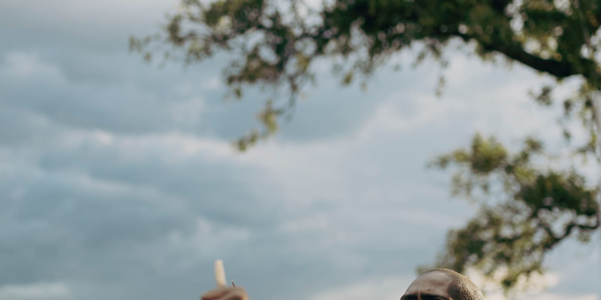 a man holding a stick in a field