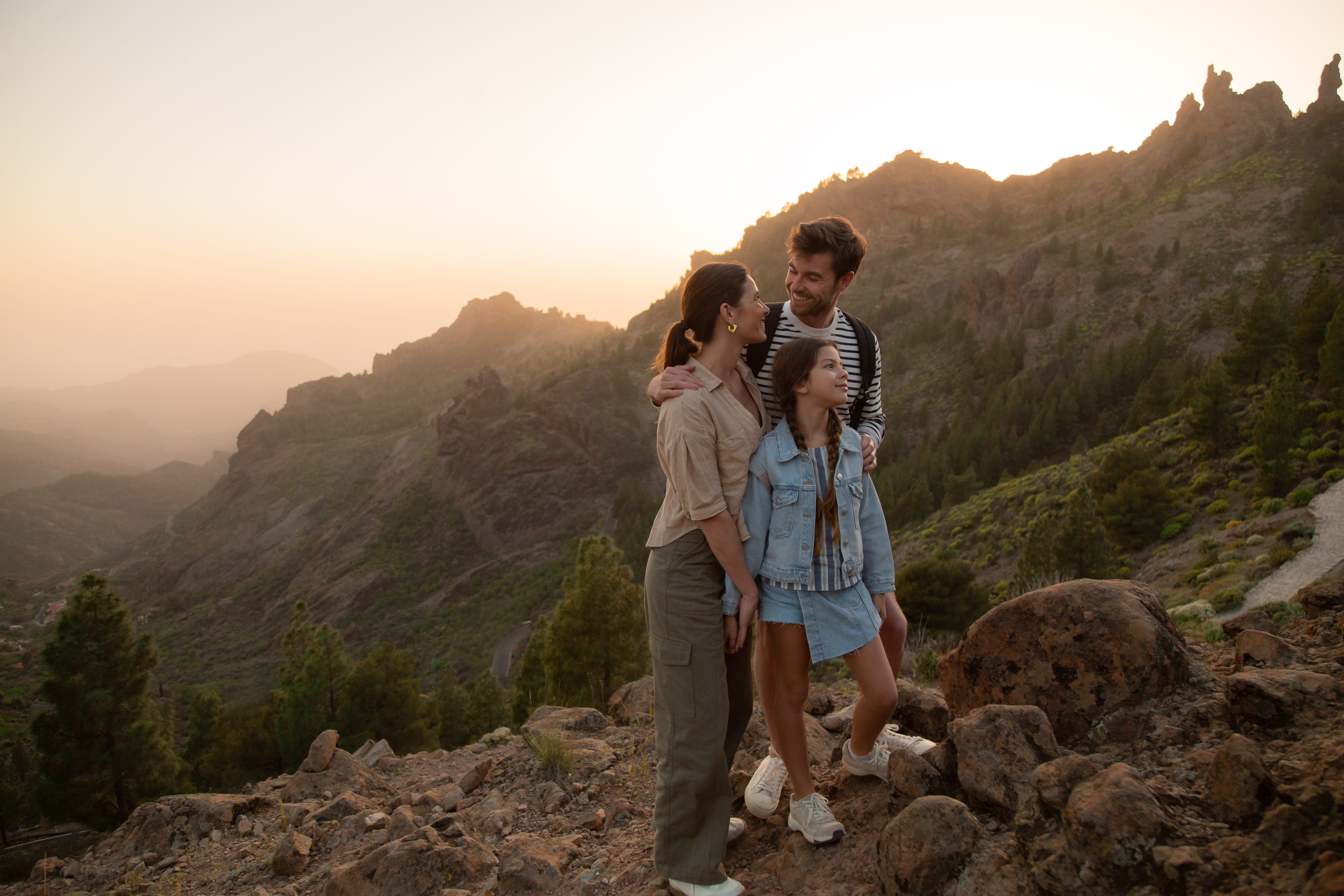 a group of people standing on a rocky hill