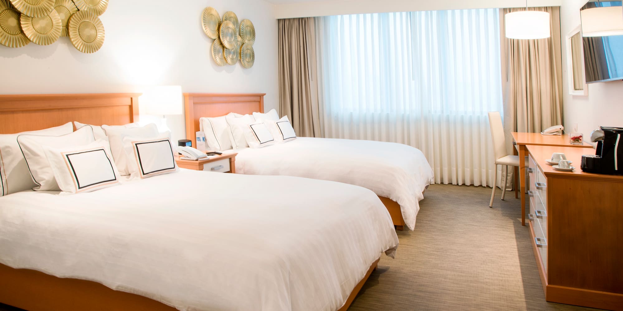 a room with two beds and a desk