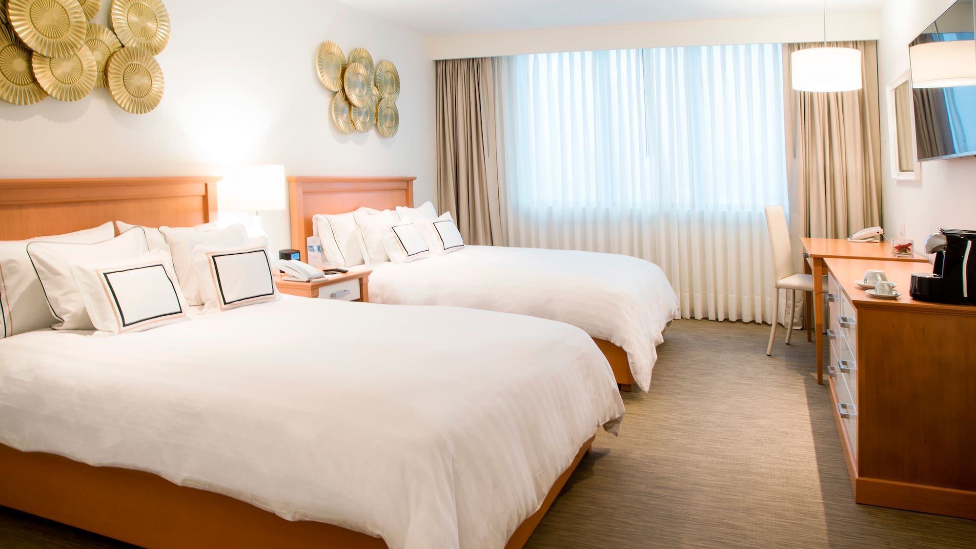 a room with two beds and a desk