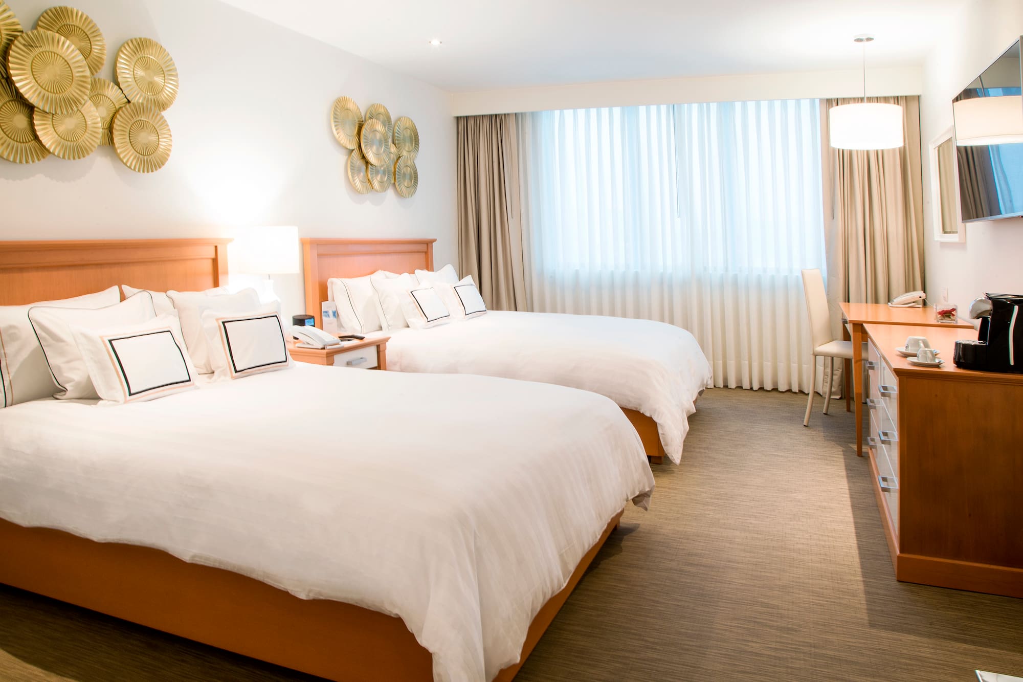 a room with two beds and a desk