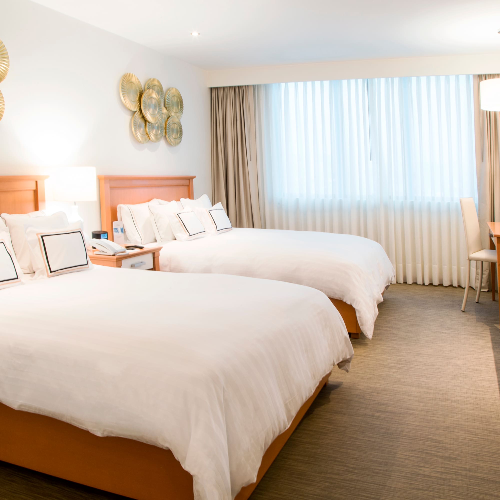 a room with two beds and a desk