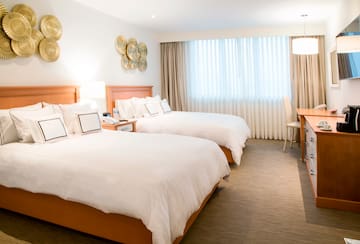 a room with two beds and a desk