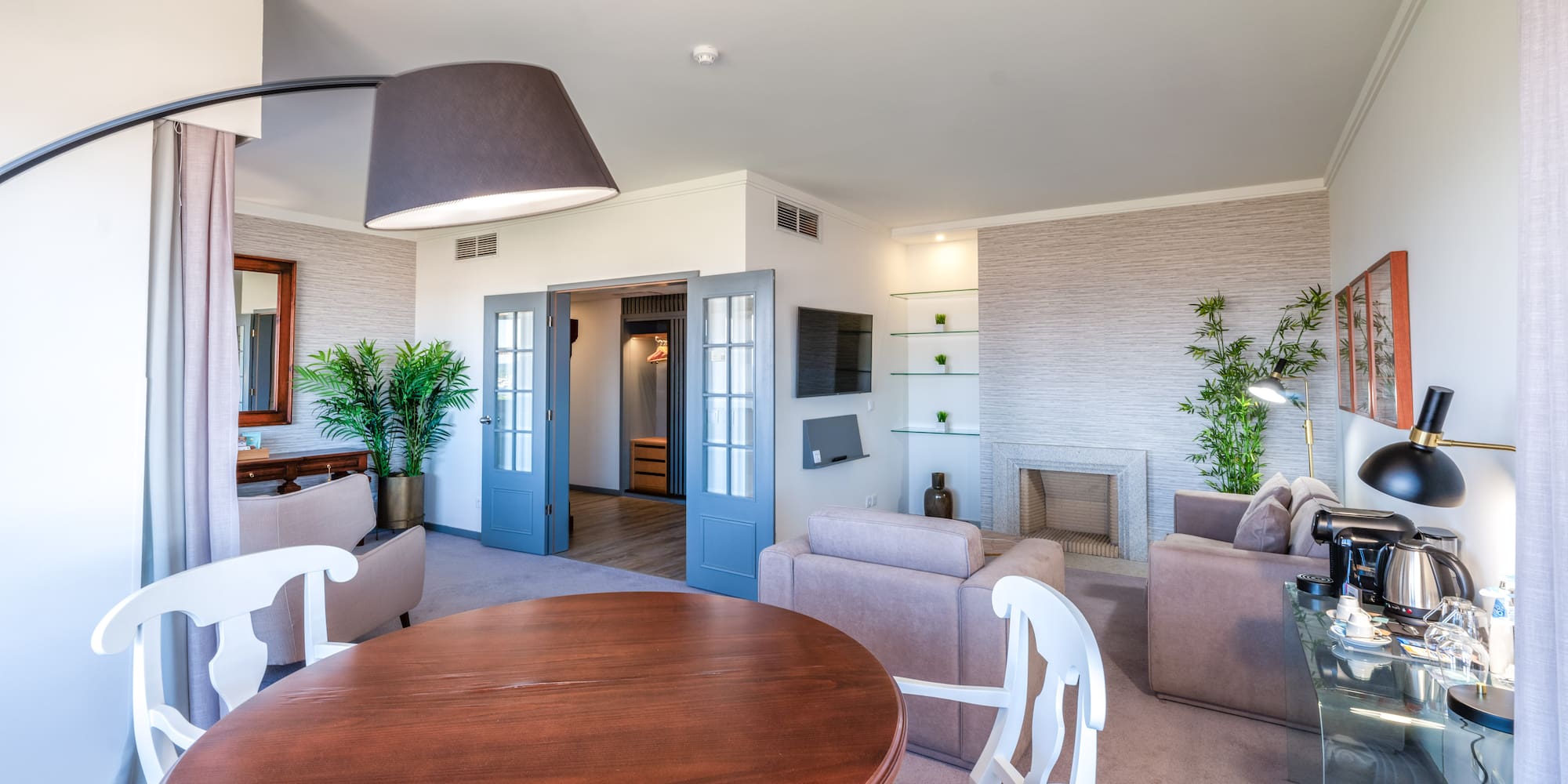 a living room with a round table and chairs
