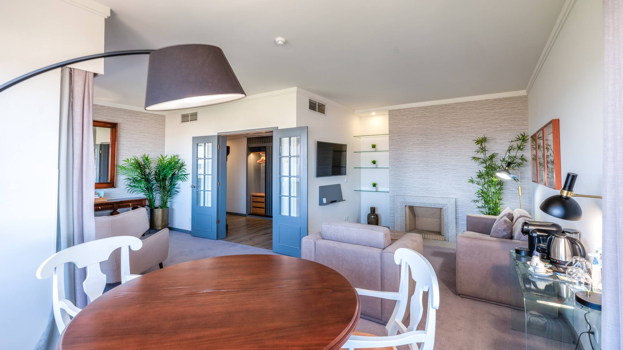 a living room with a round table and chairs