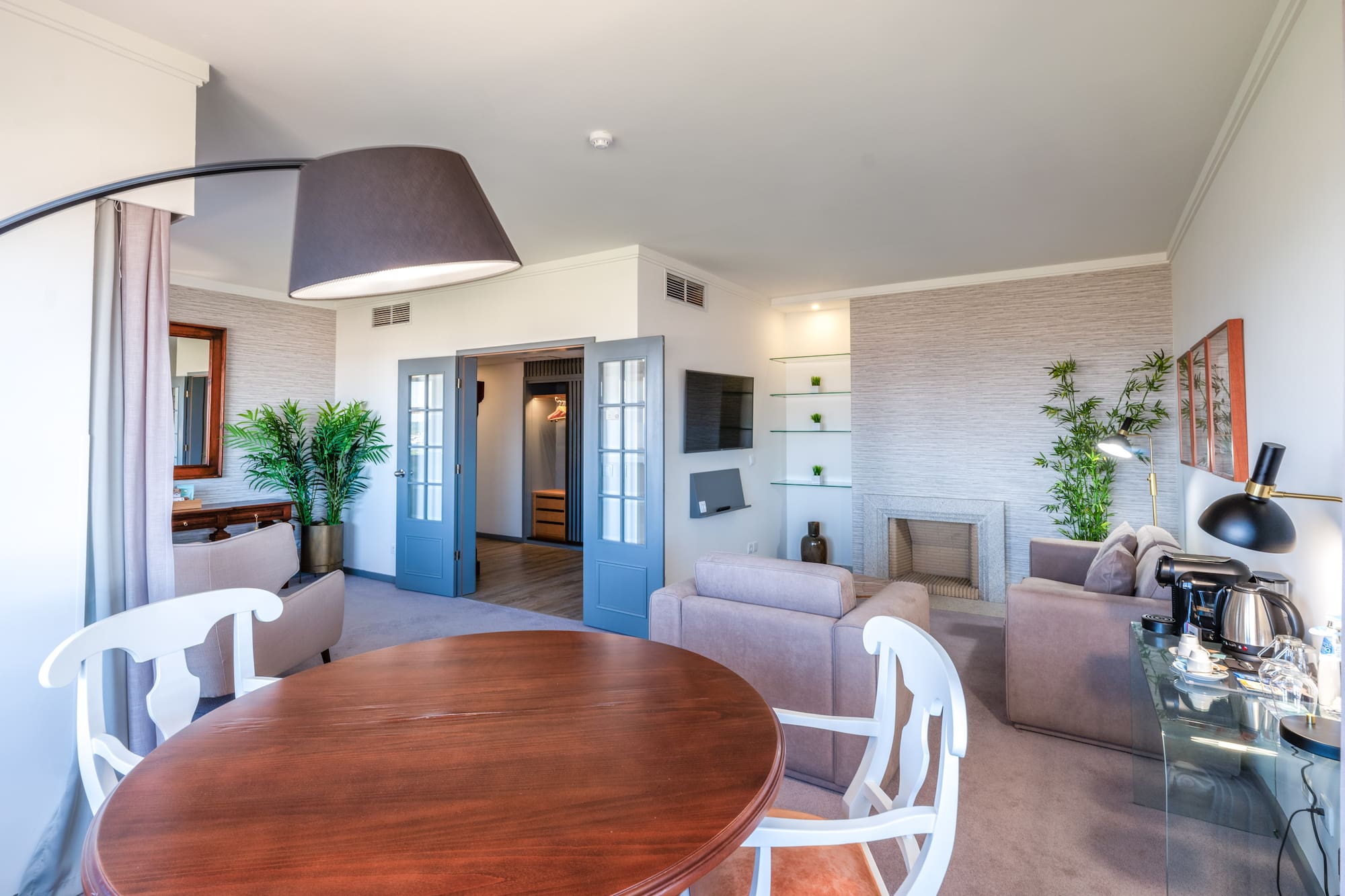 a living room with a round table and chairs