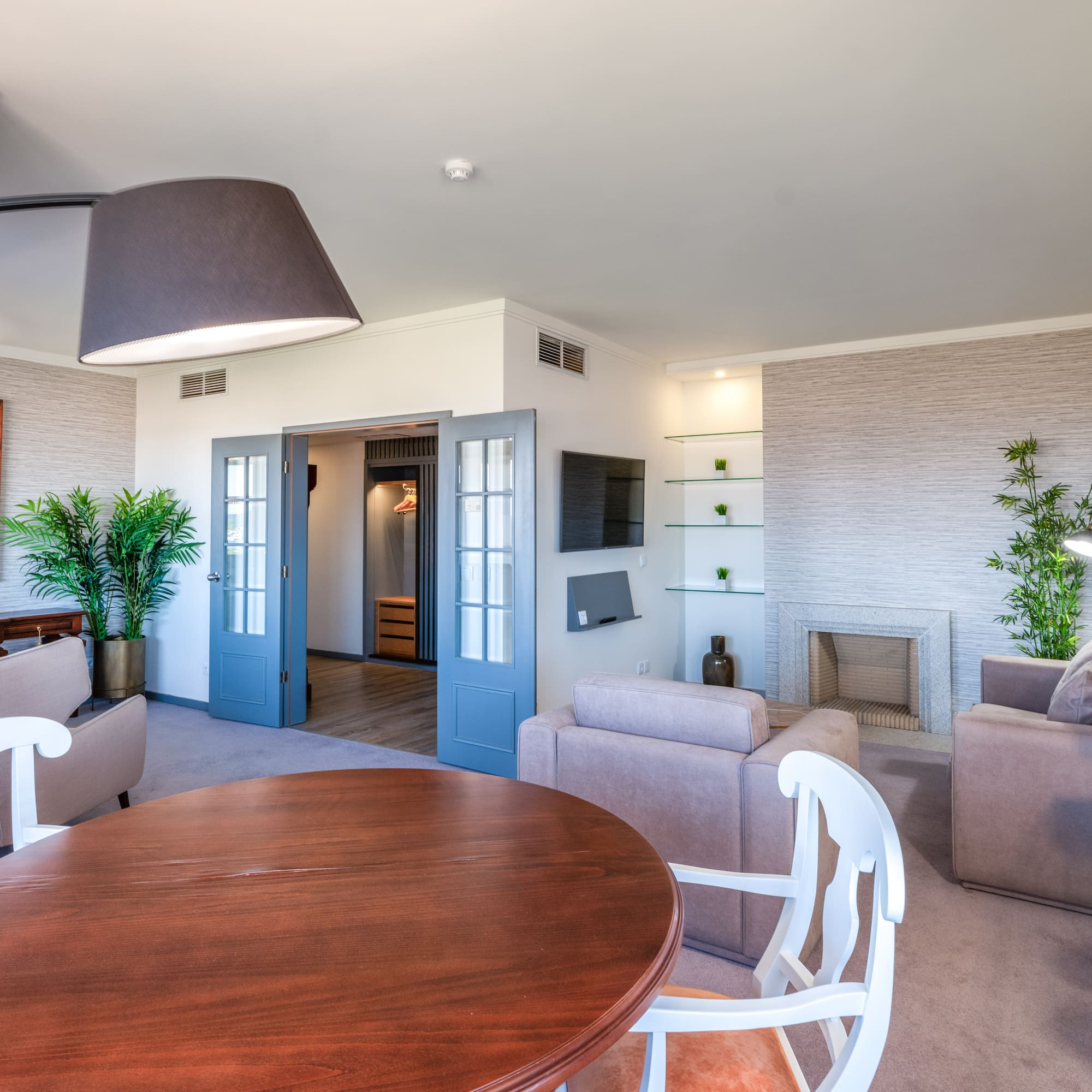 a living room with a round table and chairs