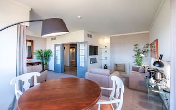 a living room with a round table and chairs