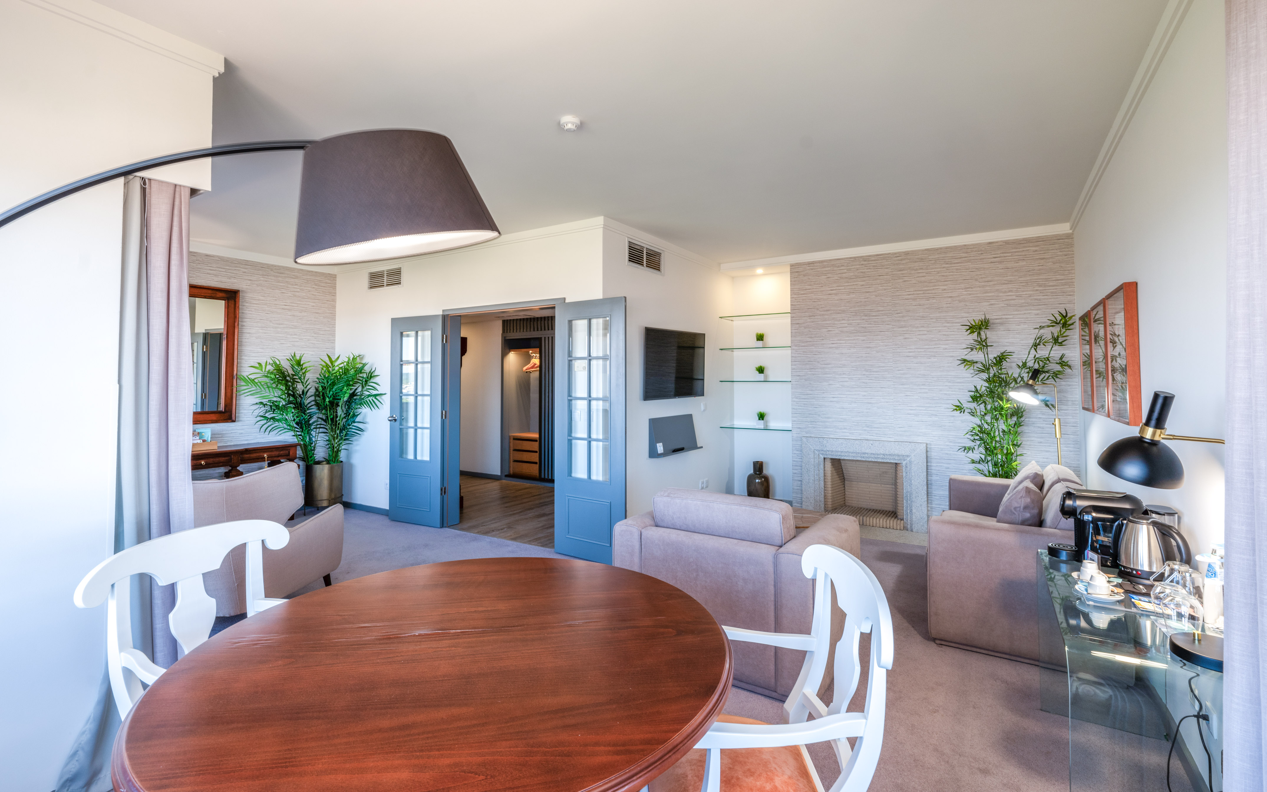 a living room with a round table and chairs