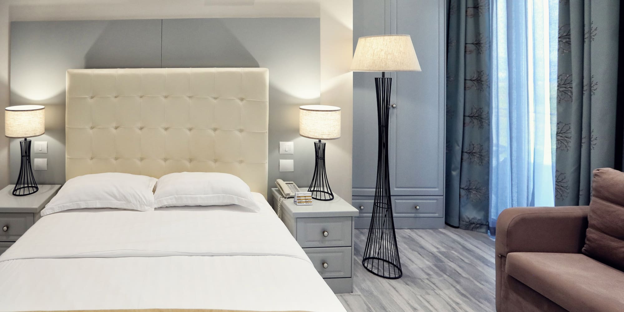 a bedroom with a bed and a lamp