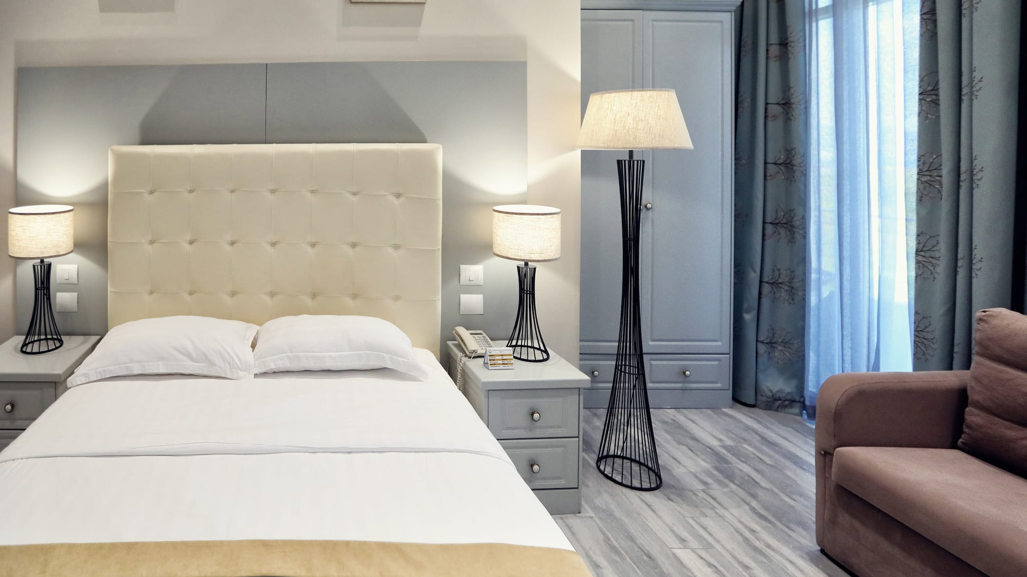 a bedroom with a bed and a lamp